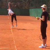 Storm Sanders (L) serves as Australian Fed Cup coach Nicole Bradtke watches on; Tennis Australia