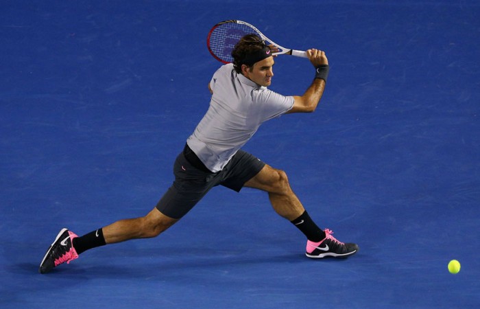 Roger Federer of Switzerland plays a backhand in his quarterfinal against Jo-Wilfred Tsonga of France on Day 10 at Australian Open 2013 at Melbourne Park; Getty Images
