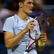 Bernard Tomic adjusts his racquet between points during his 6-3 6-3 third round loss to No.1 seed Juan Martin Del Potro at the ATP/WTA Citi Open in Washington, DC; Getty Images