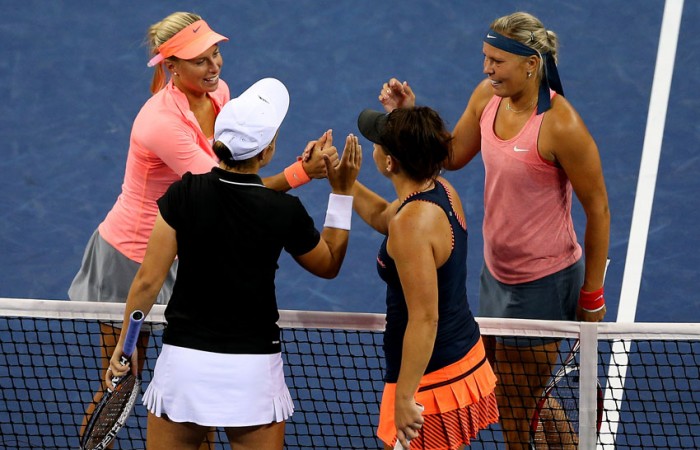 Andrea Hlavackova (top left) and Lucie Hradecka (top right) of Czech Republic shake hands at the net with Ash Barty (bottom left) and Casey Dellacqua of Australia after winning the US Open women's doubles final; Getty Images