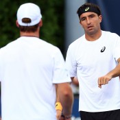 Marinko Matosevic (R) talks to his partner Grega Zemlja of Slovenia during their 1-6 6-3 6-2 first round men's doubles loss to Russians Nikolay Davydenko and Mikhail Elgin at the 2013 US Open; Getty Images