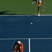 Ash Barty serves behind her partner Casey Dellacqua of Australia during their women's doubles semifinal victory over Sania Mirza of India and Jie Zheng of China; Getty Images
