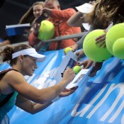 Sam Stosur signs autographs for fans following her first round-robin victory over Elena Vesnina at the WTA Tournament of Champions in Sofia, Bulgaria; Desislava Kulelieva
