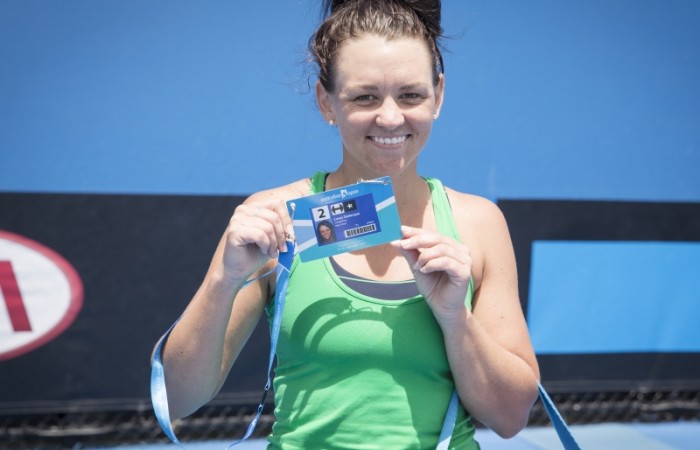 Casey Dellacqua poses with her Australian Open player accreditation after winning the Australian Open Play-off final over Arina Rodionova; Emily Mogic