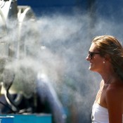A tennis fan cools off in front of a mister fan as Melbourne heads towards 43 degrees celsius (109 degrees fahrenheit) during day two of the 2014 Australian Open at Melbourne Park on January 14, 2014 in Melbourne, Australia.  (Photo by Matt King/Getty Images)