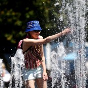  A tennis fan cools off in a fountain as Melbourne heads towards 43 degrees celsius (109 degrees fahrenheit) during day two of the 2014 Australian Open at Melbourne Park on January 14, 2014 in Melbourne, Australia.  (Photo by Matt King/Getty Images)