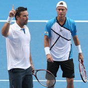 MELBOURNE, AUSTRALIA - JANUARY 15:  Lleyton Hewitt of Australia talks tactics with Patrick Rafter of Australia in their first round doubles match against Eric Butorac of the United States and Raven Klaasen of South Africa during day three of the 2014 Australian Open at Melbourne Park on January 15, 2014 in Melbourne, Australia.  (Photo by Clive Brunskill/Getty Images)