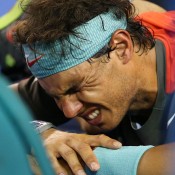 MELBOURNE, AUSTRALIA - JANUARY 26:  Rafael Nadal of Spain reacts as he appears to be injured in his men's final match against Stanislas Wawrinka of Switzerland during day 14 of the 2014 Australian Open at Melbourne Park on January 26, 2014 in Melbourne, Australia.  (Photo by Scott Barbour/Getty Images)