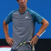 MELBOURNE, AUSTRALIA - JANUARY 18:  Thanasi Kokkinakis of Australia looks on in his first round mixed doubles match with Donna Vekic of Croatia against Julia Goerges of Germany and Aisam-Ul-Haq Qureshi of Pakistan during day six of the 2014 Australian Open at Melbourne Park on January 18, 2014 in Melbourne, Australia.  (Photo by Mark Kolbe/Getty Images)