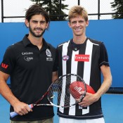 MELBOURNE, AUSTRALIA - JANUARY 18:  Collingwood AFL player Brodie Grundy (L) and Kevin Anderson of South Africa pose after trying each others sports during day 6 of the 2014 Australian Open at Melbourne Park on January 18, 2014 in Melbourne, Australia.  (Photo by Graham Denholm/Getty Images)