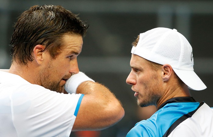 MELBOURNE, AUSTRALIA - JANUARY 15:  Pat Rafter of Australia and Lleyton Hewitt of Australia talk between points in their first round men's doubles match against Eric Butorac of the United States and Raven Klassen of South Africa during day three of the 2014 Australian Open at Melbourne Park on January 15, 2014 in Melbourne, Australia.  (Photo by Scott Barbour/Getty Images)