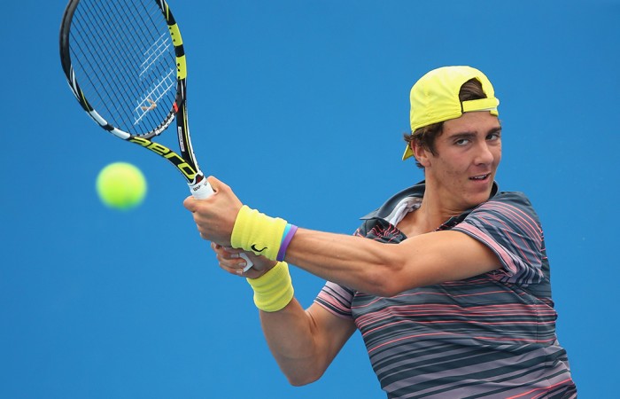 Thanasi Kokkinakis of Australia plays a backhand in his match against Di Wu of China during day two of the 2014 Brisbane International at Queensland Tennis Centre on December 30, 2013 in Brisbane, Australia.  (Photo by Chris Hyde/Getty Images)