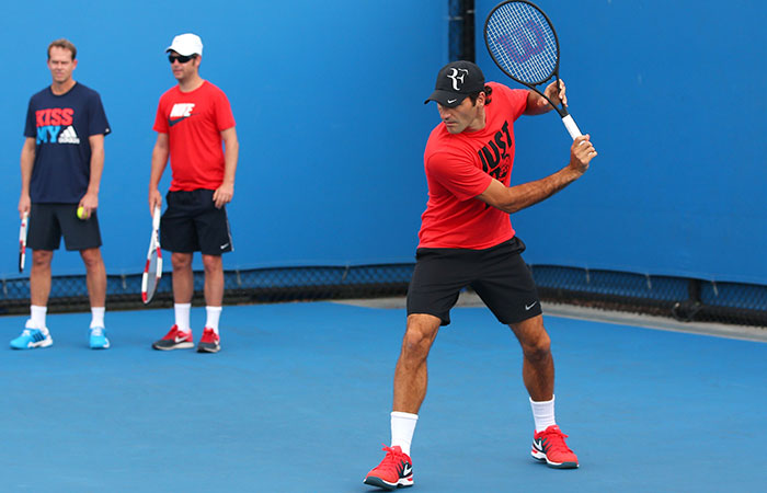 Roger Federer practices while Stefan Edberg (left) and Severin Luthi watch from the sidelines, Australian Open, Melbourne, 2014. GETTY IMAGES