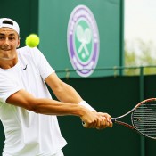 Bernard Tomic in action during his first round win over Russian Evgeny Donskoy at the 2014 Wimbledon Championships; Getty Images