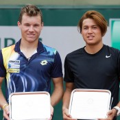 Akira Santillan (R) and Lucas Miedler pose with their trophies after finishing runners-up in the boys' doubles final at Roland Garros; Elizabeth Xue Bai