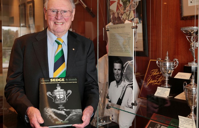 Frank Sedgman poses with his biography at Kooyong Lawn Tennis Club; Fiona Hamilton