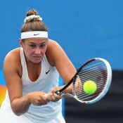Sara Tomic of Australia plays a backhand in her first round match against Arina Rodionova of Australia during the 2015 Australian Open play off at Melbourne Park on December 16, 2014 in Melbourne, Australia.  (Photo by Robert Prezioso/Getty Images)