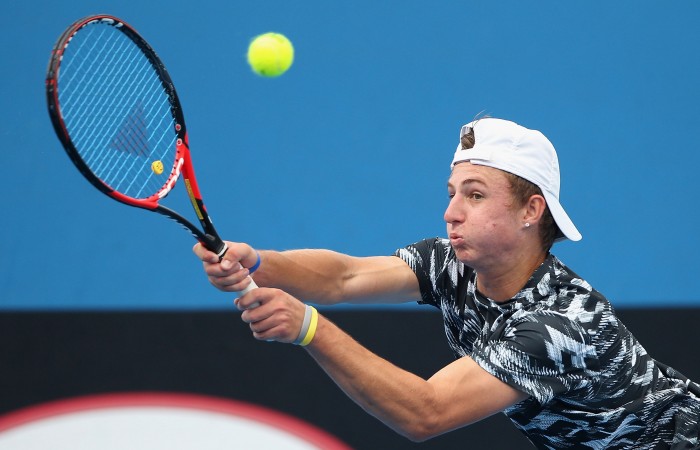 Omar Jasika of Australia plays a backhand in his qualifying match against Mathias Bourgue of France for 2015 Australian Open at Melbourne Park on January 14, 2015 in Melbourne, Australia.  (Photo by Robert Prezioso/Getty Images)