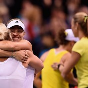Angelique Kerber celebrates her victory over Sam Stosur in the reverse singles of the Australia v Germany Fed Cup tie in Stuttgart with German captain Barbara Rittner; Getty Images