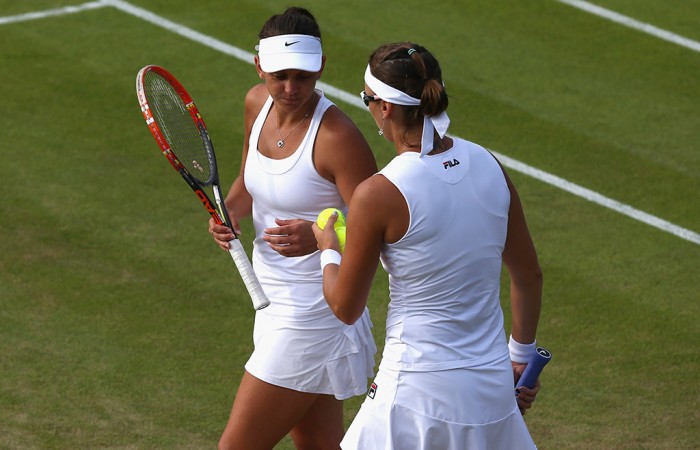 Casey Dellacqua (L) and Yaroslava Shvedova in action during the women's doubles quarterfinals at Wimbledon; Getty Images