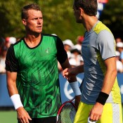 Lleyton Hewitt (L) talks to Aleksandr Nedovyesov at net after the Kazakh was forced to retire from their first-round match; Getty Images