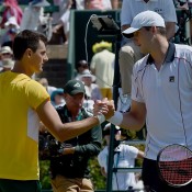 John Isner (R) shakes hands with Bernard Tomic after winning the reverse singles rubber of the Australia v United States Davis Cup World Group tie at Kooyong; Getty Images