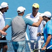 Andrew Florent (front, left) hugs Wayne Ferreira in the Australian Open 2014 legends event; Getty Images