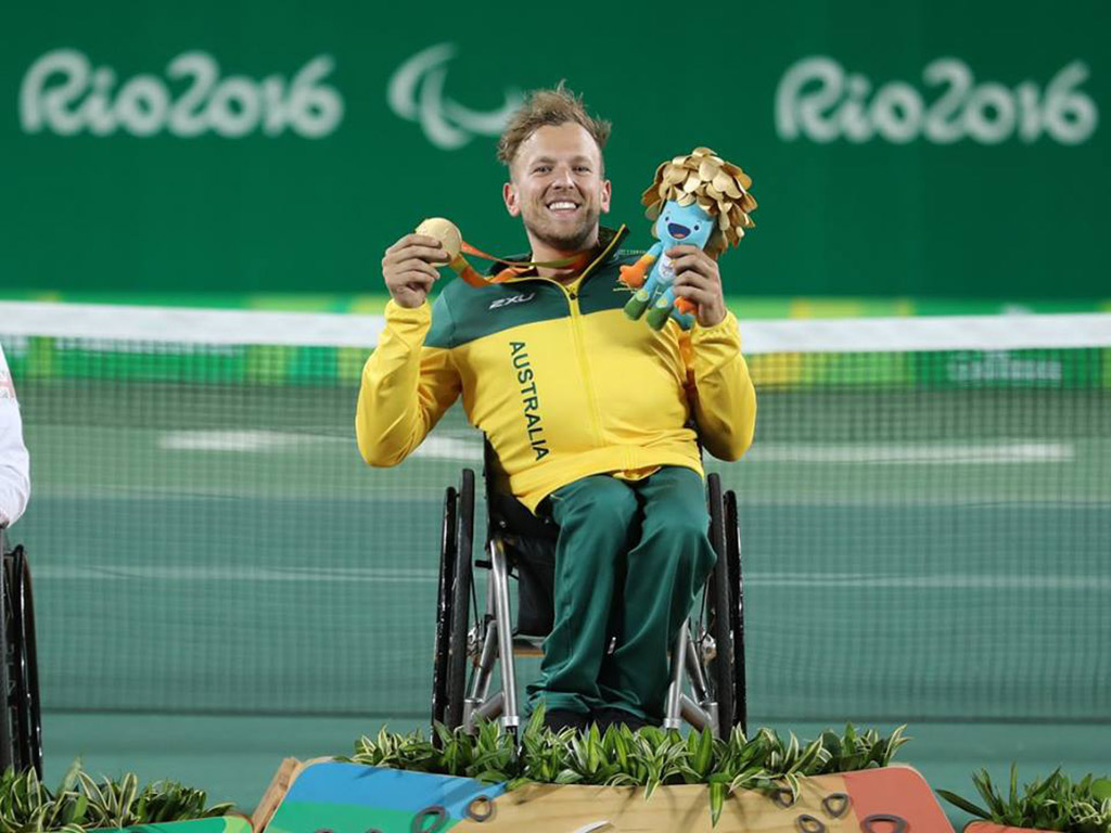 Dylan Alcott poses with his gold medal after winning the quads singles event at the Rio 2016 Paralympics; ITF Wheelchair Tennis
