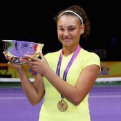 Violet Apisah poses with her trophy after winning the WTA Future Stars tournament in Singapore; Getty Images