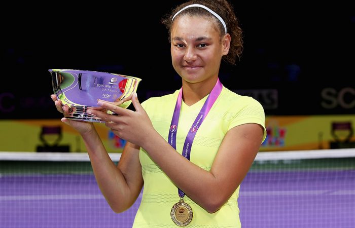 Violet Apisah poses with her trophy after winning the WTA Future Stars tournament in Singapore; Getty Images