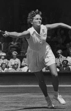Australian tennis player Beryl (Penrose) Collier seen competing against Louise Brough in the 1955 Wimbledon quarterfinals; Getty Images