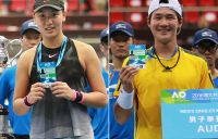 Xinyu Wang (L) and Soon Woo Kwon pose with their Australian Open player accreditation passes after winning the women's and men's singles events at the Asia-Pacific Wildcard Play-off in Zhuhai.