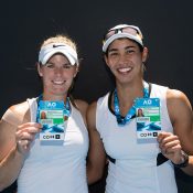 Belinda Woolcock (L) and Astra Sharma pose with their Australian Open player accreditations after winning the women's doubles AO Play-off event at Melbourne Park (photo credit Elizabeth Xue Bai)