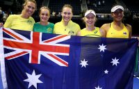 The Australian Fed Cup team pose with the Aussie flag after winning their World Group Play-Off tie against the Netherlands in Wollongong; Getty Images