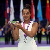 Annerly Poulos poses with her trophy after finishing runner-up in the U16 WTA Future Stars event in Singapore; Getty Images