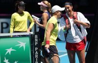 The Australian and French Fed Cup teams chat as they cross over between practice sessions at RAC Arena in Perth. (Getty Images)