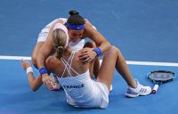 Caroline Garcia embraces Kristina Mladenovic (sitting) after the duo beat Ash Barty and Sam Stosur in the fifth rubber to win the Fed Cup title for France. (Getty Images)