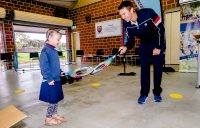MAKING A RACQUET: Doubles champion John Peers gifts a new tennis racquet to a first year primary school student in Perth. Picture: Tennis Australia
