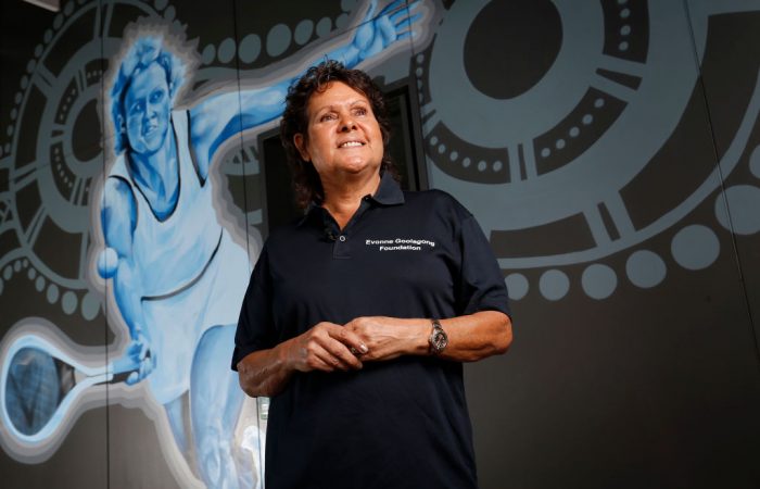 Evonne Goolagong Cawley stands in front of a mural of her painted by a group of local artists, including David Collins and Indigenous artists Shaun Lee ‘Hafleg’ and Jesse Bell to celebrate and recognise her incredible achievements during the National Indigenous Tennis Carnival at the Darwin International Tennis Centre. 