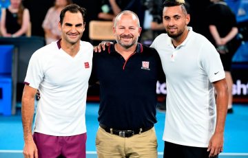 SHOWING SUPPORT:
Roger Federer and Nick Kyrgios with a volunteer firefighter during the AO Rally for Relief event at Rod Laver Arena in January. Picture: Getty Images