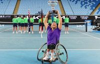 Dylan Alcott lifts an Australian Open quad wheelchair singles trophy for the seventh time.
