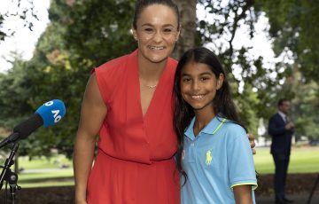 AO 2022 champion Ash Barty with a young fan at her trophy photo shoot today in Melbourne. Picture: Tennis Australia