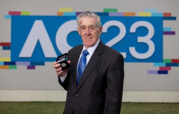 Ken Rosewall with the Australian Open 2023 coin. Picture: Tennis Australia