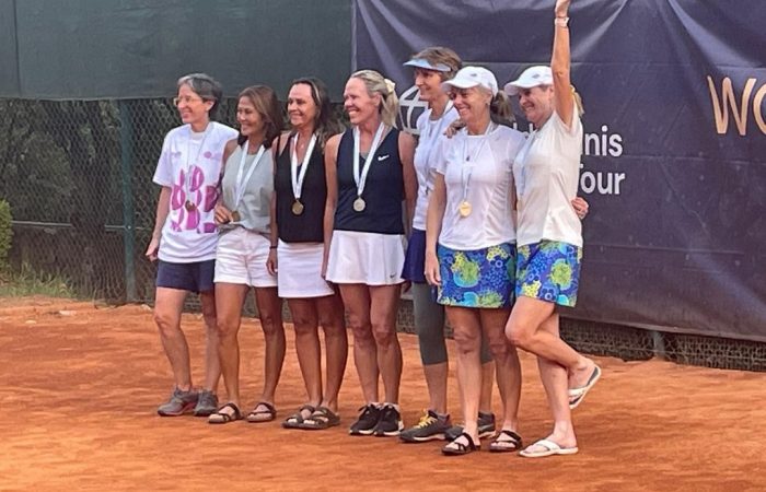 Australian pair Kerryn Cyrien and Jill Meggs, far right, celebrate winning a women's doubles gold medal at the ITF Masters World Championships.
